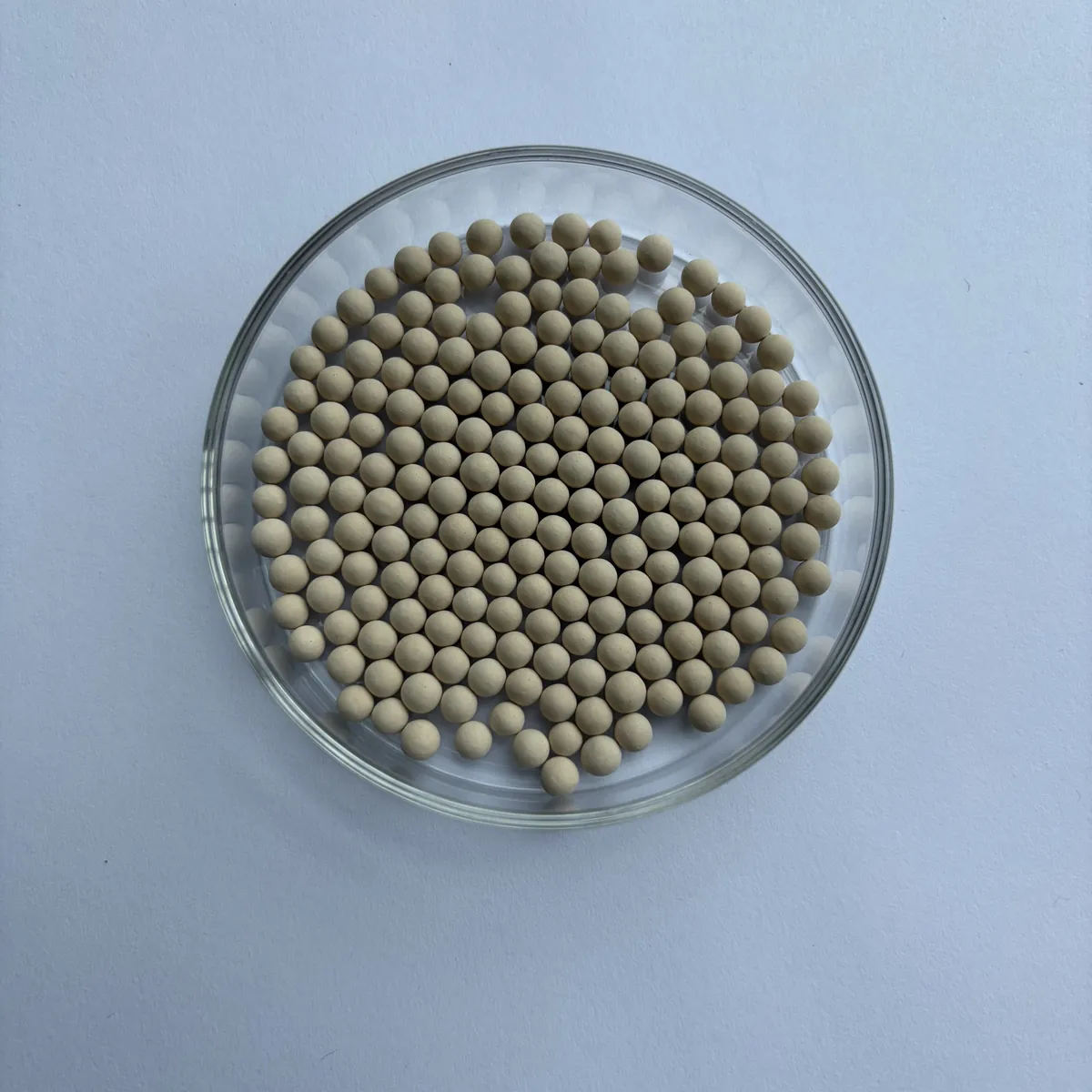 SQ 3A molecular sieve beads (SQ-3A-B) in a glass dish